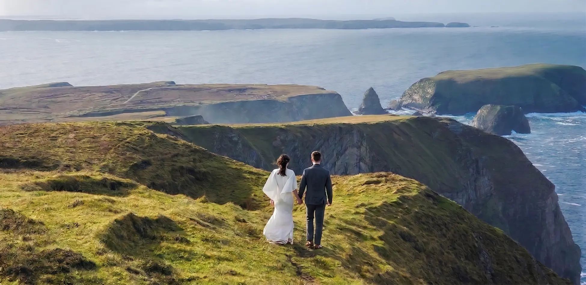 Destination wedding in Ireland — castle, Atlantic cliffs and emerald landscape at golden hour